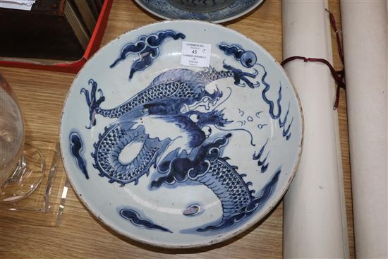 A Chinese blue and white deep plate decorated with a dragon and two other items